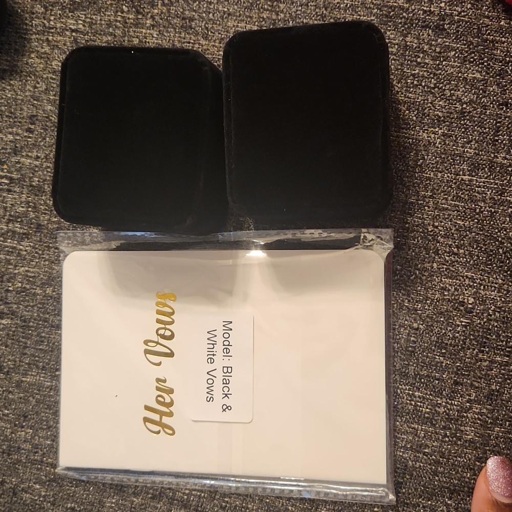 Wedding items. Two matching ring boxes and his and her vow books